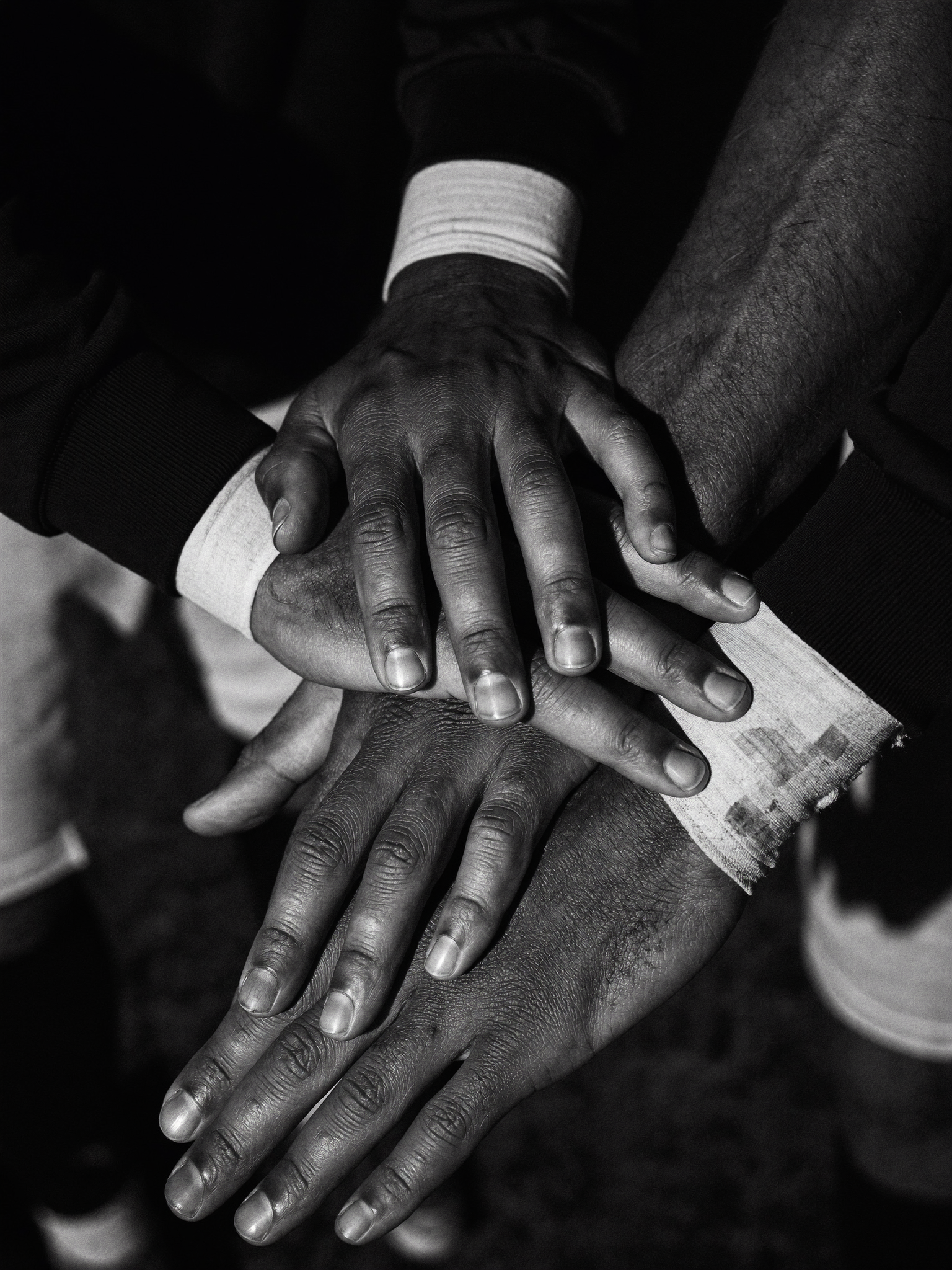 Hands stacked in a team huddle