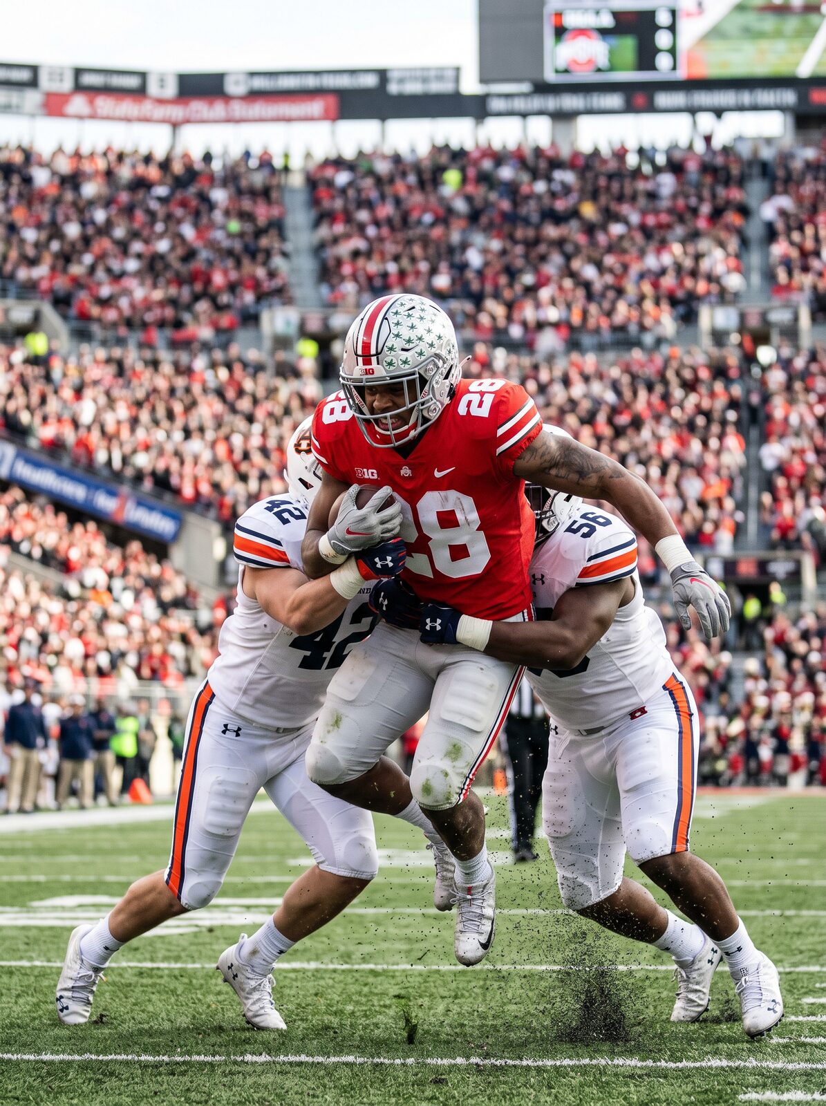 Ohio State running back breaking through a tackle